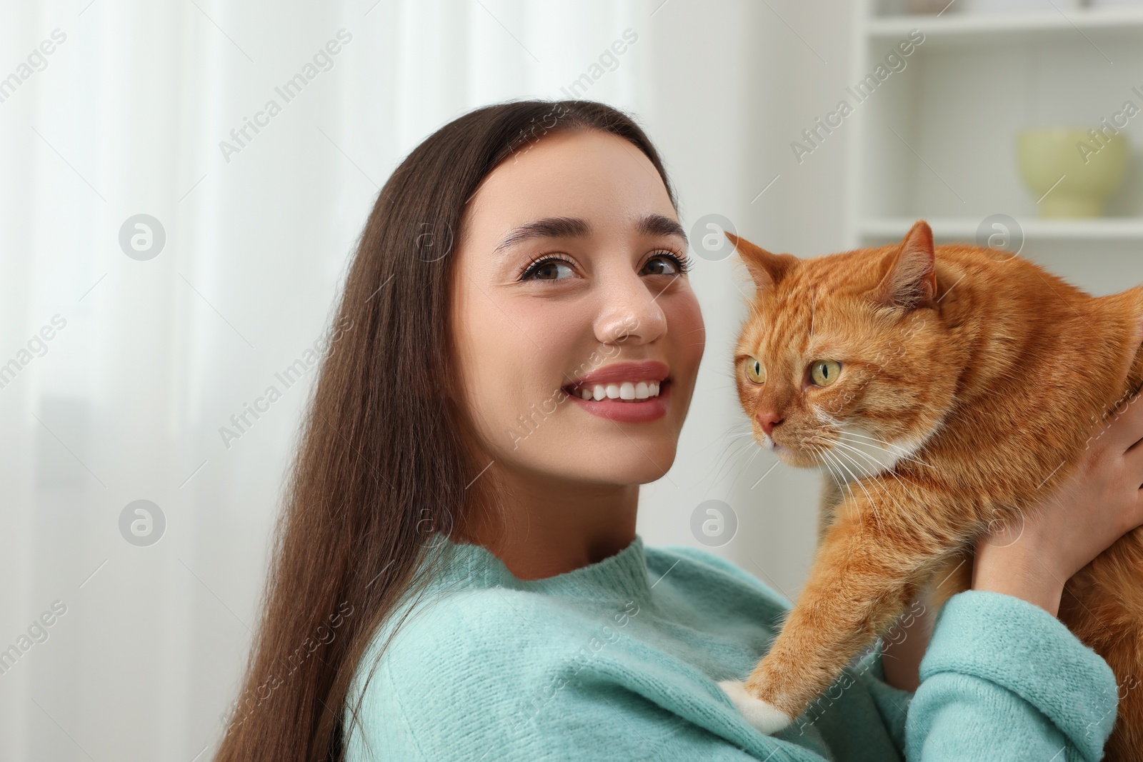 Photo of Beautiful woman with cute cat at home