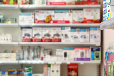 Image of Blurred view of shelves with pharmaceuticals in modern drugstore