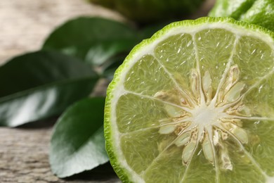 Photo of Half of fresh ripe bergamot fruit on table, closeup. Space for text