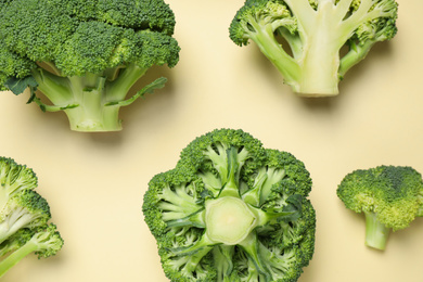 Photo of Fresh broccoli on beige background, flat lay