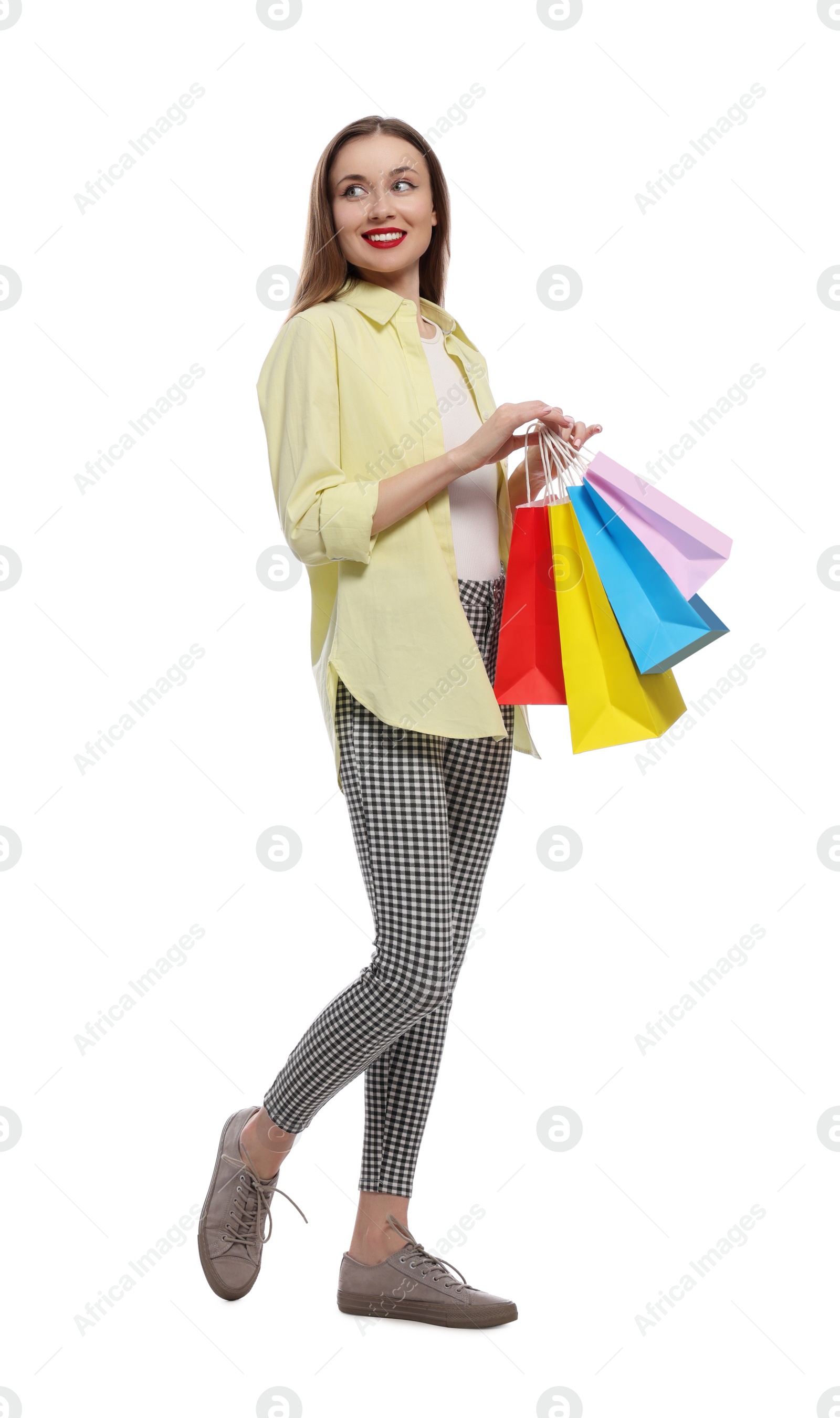 Photo of Stylish young woman with shopping bags on white background