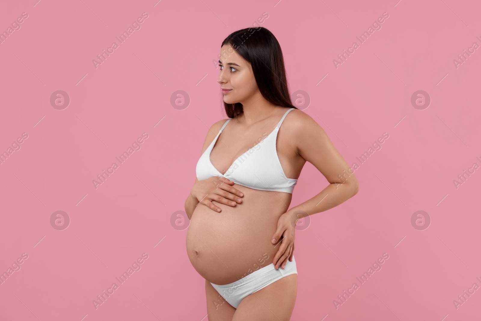 Photo of Beautiful pregnant woman in stylish comfortable underwear on pink background