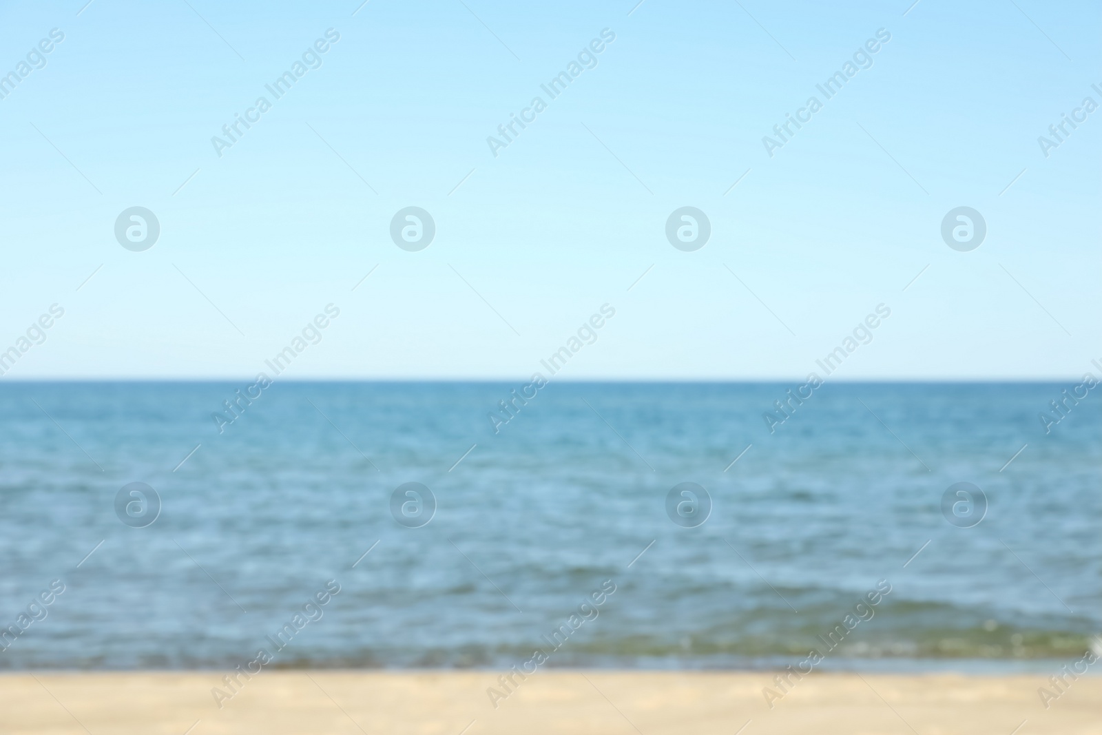 Photo of Blurred view of sandy beach near sea