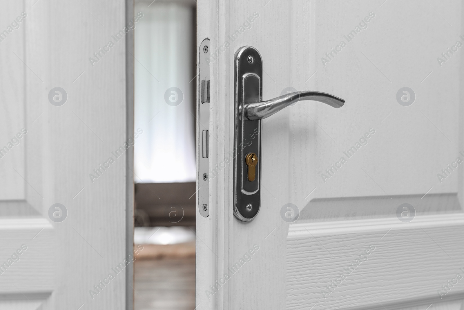 Photo of Closeup of open door in modern apartment