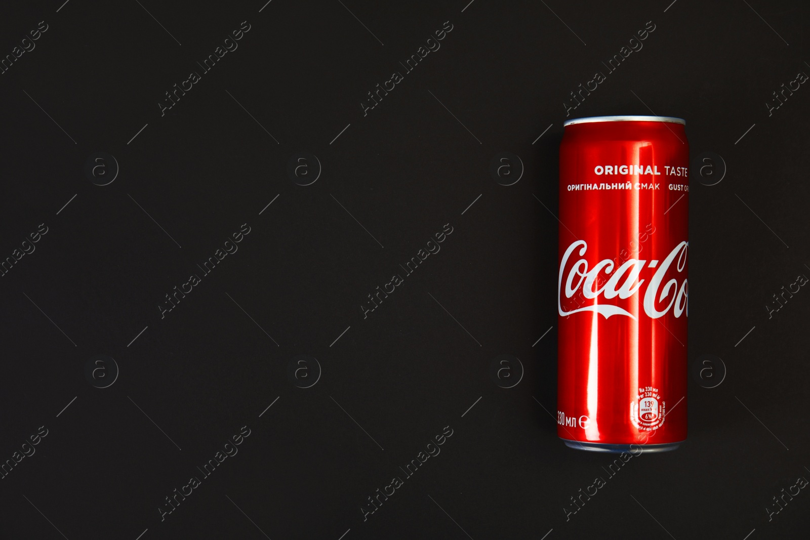 Photo of MYKOLAIV, UKRAINE - NOVEMBER 14, 2018: Coca-Cola can on black background, top view. Space for text