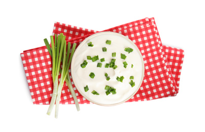 Photo of Fresh sour cream with onion and fabric on white background, top view