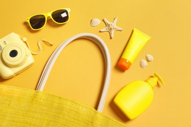 Flat lay composition with beach accessories on color background