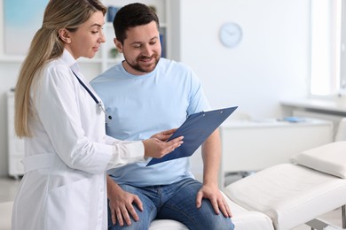 Photo of Professional doctor working with patient in hospital, space for text