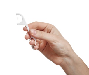 Photo of Woman holding dental floss pick on white background. Mouth and teeth care
