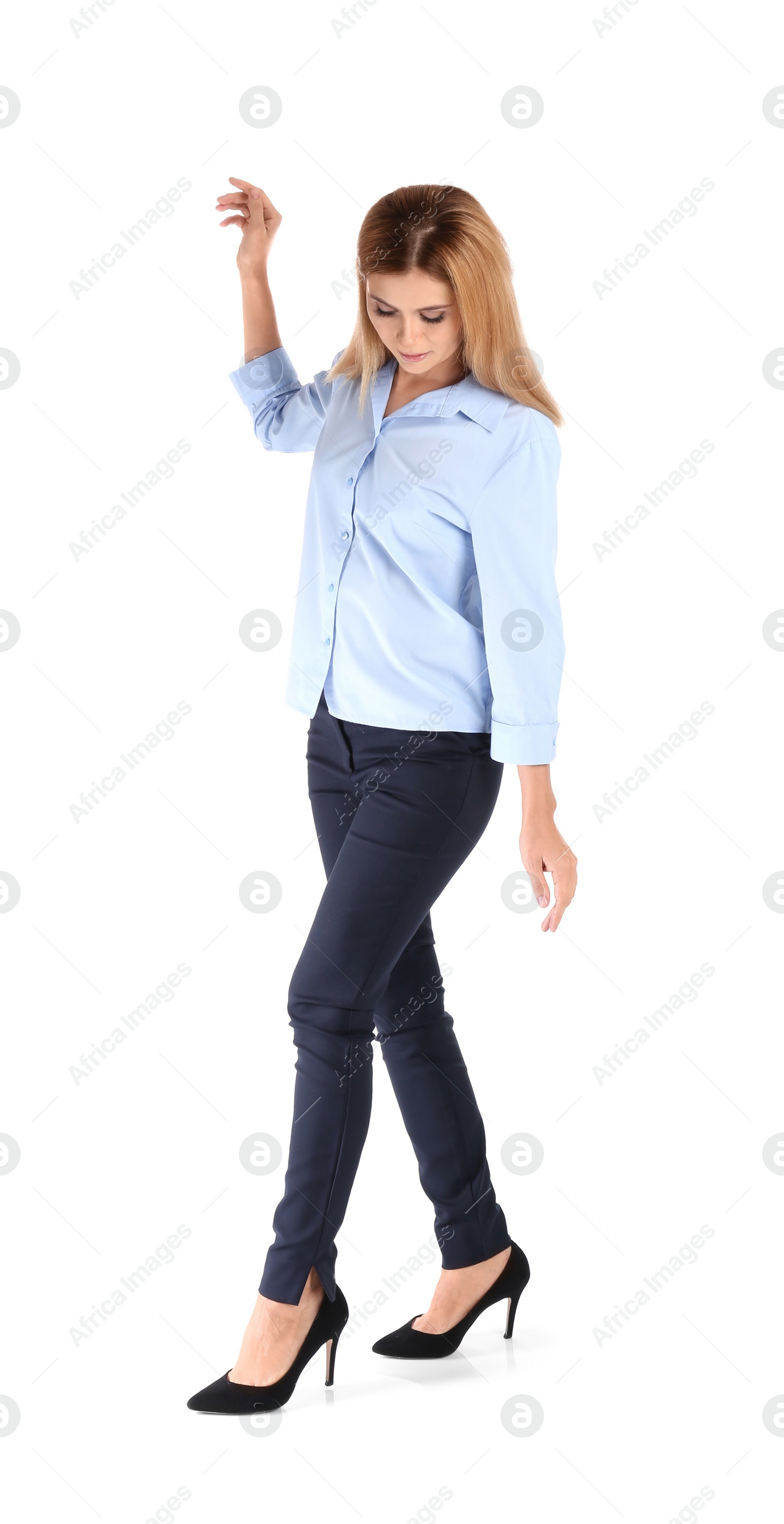 Photo of Full length portrait of businesswoman balancing on white background