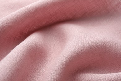 Photo of Texture of pink crumpled fabric as background, closeup