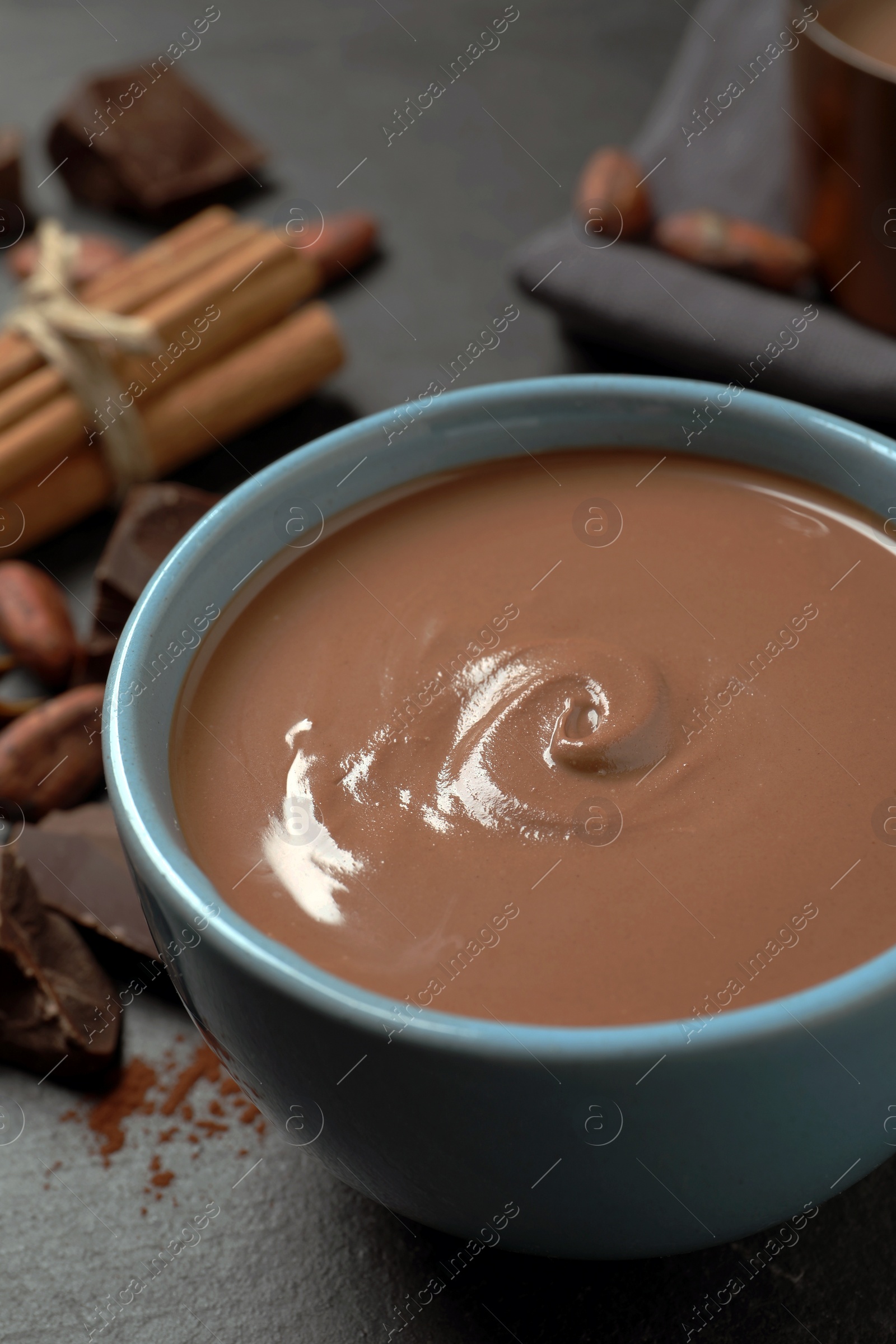 Photo of Yummy hot chocolate in cup on black table