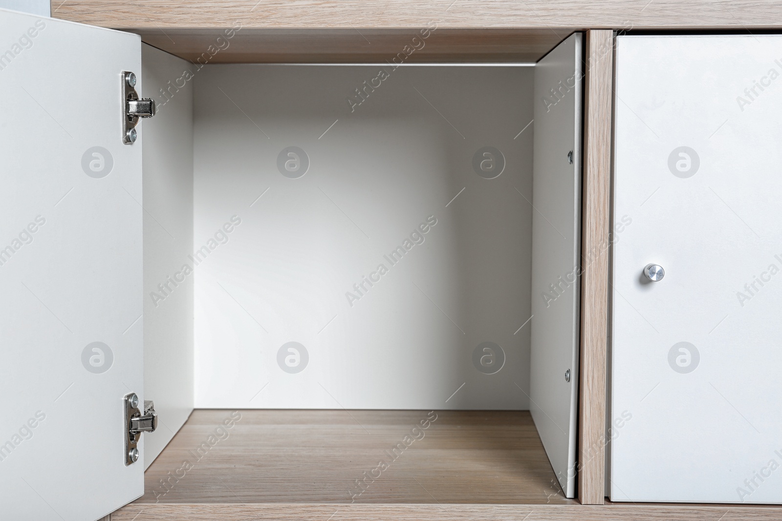 Photo of Empty wardrobe compartments, closeup view. Stylish furniture