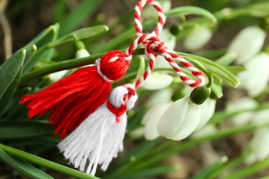 Photo of Traditional martisor and fresh snowdrop flowers outdoors, closeup