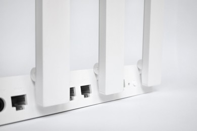 Photo of One modern Wi-Fi router on white background, closeup