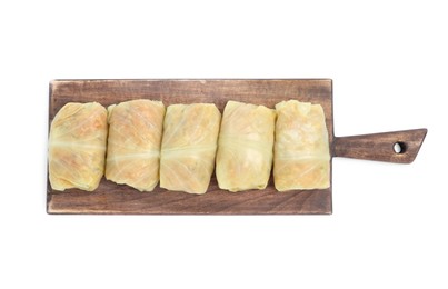 Wooden board with uncooked stuffed cabbage rolls on white background, top view