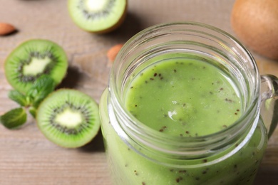 Photo of Delicious kiwi smoothie in mason jar, closeup