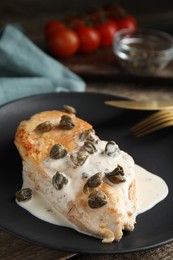 Photo of Delicious chicken fillet with capers and sauce on plate, closeup