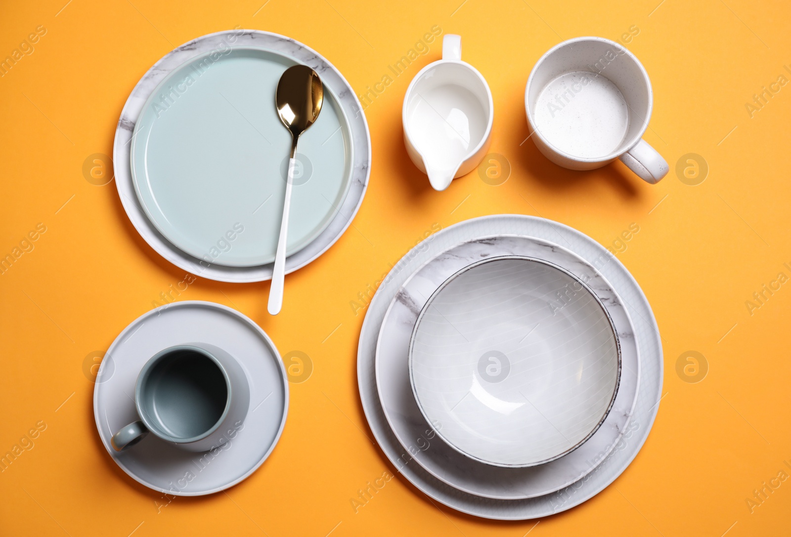 Photo of Beautiful table setting on orange background, flat lay