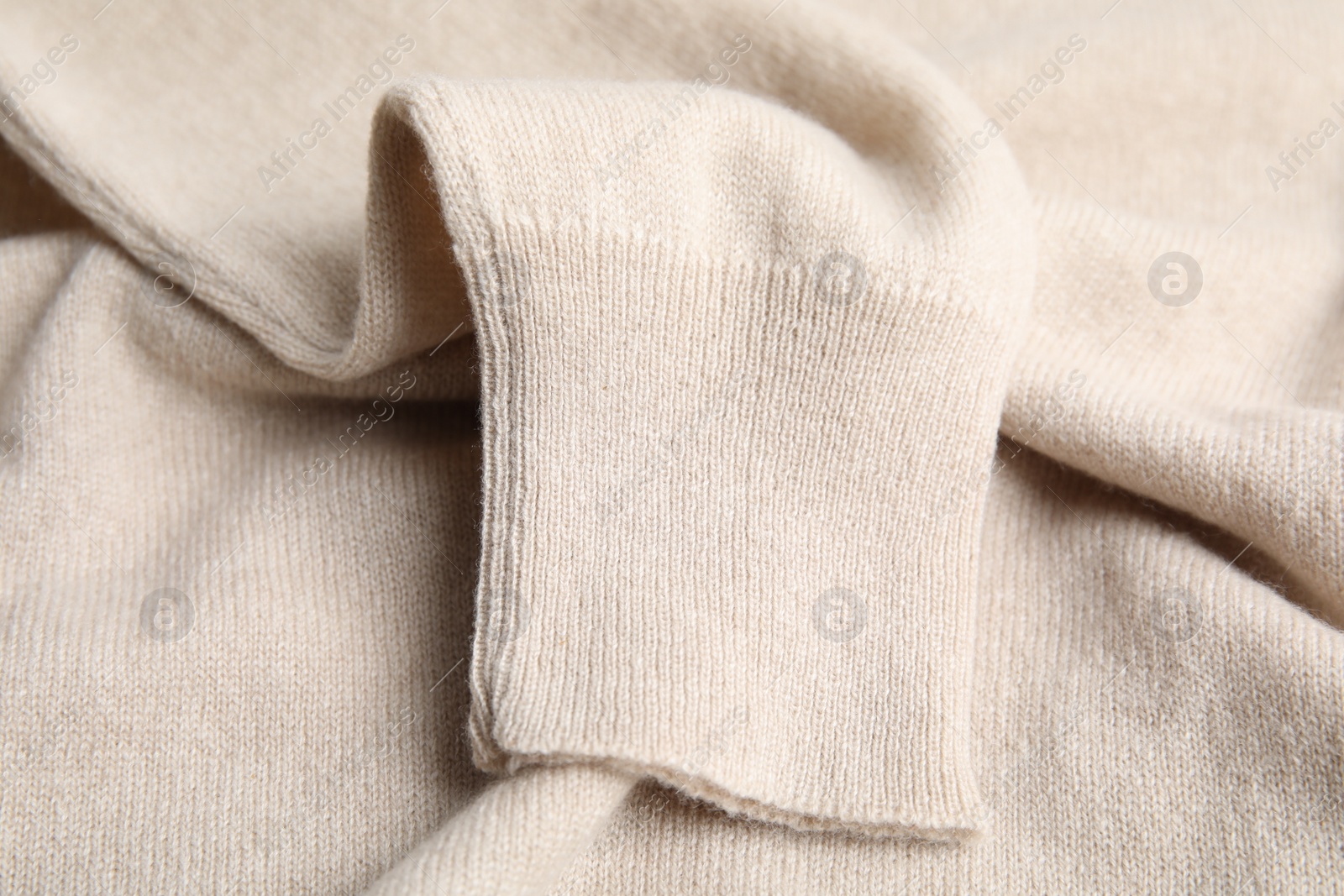 Photo of Warm cashmere sweater as background, closeup view