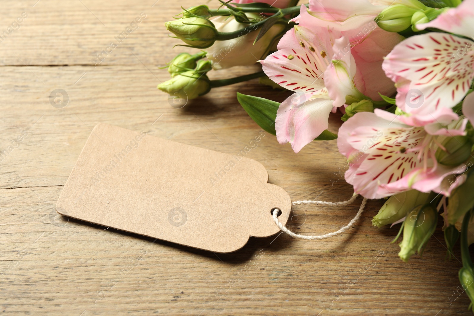 Photo of Happy Mother's Day. Beautiful flowers with blank card on wooden table, closeup