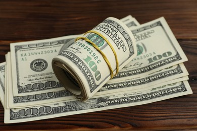 Money exchange. Dollar banknotes on wooden background, closeup