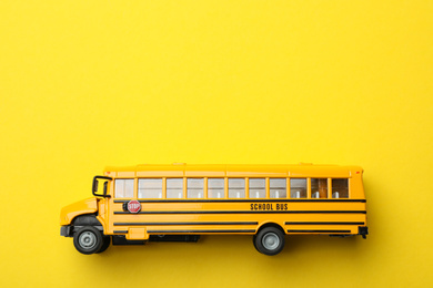 Photo of School bus on yellow background, top view with space for text. Transport service