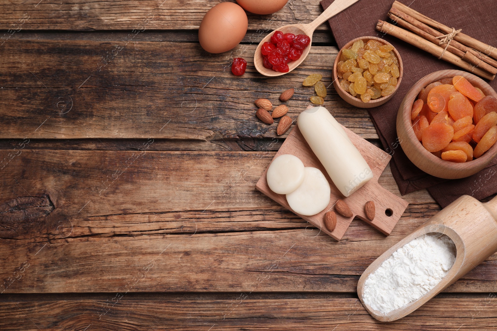 Photo of Ingredients for homemade Stollen on wooden table, flat lay. Baking traditional German Christmas bread