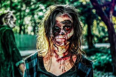 Photo of Scary zombies with bloody faces outdoors. Halloween monster