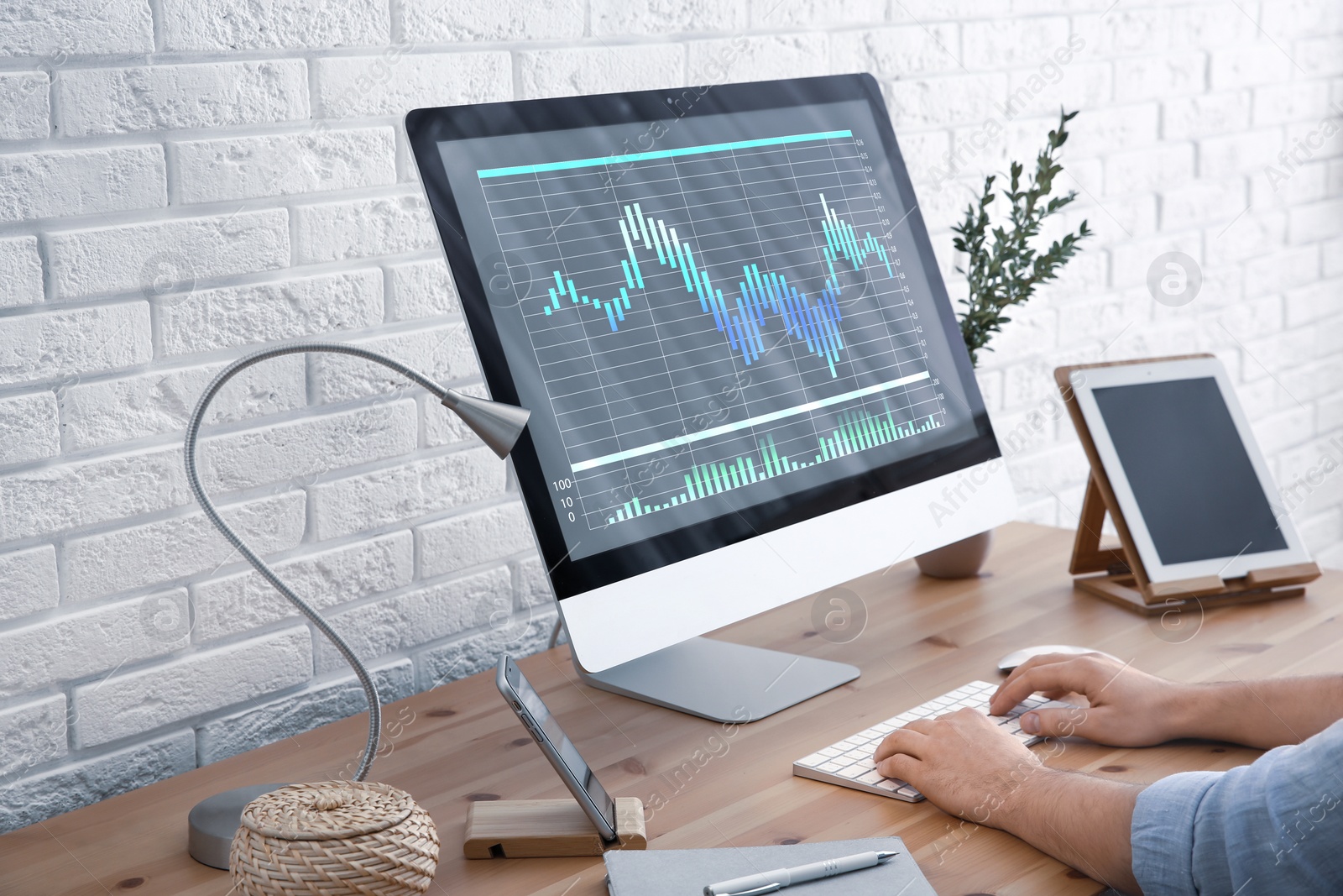 Image of Broker using modern computer at table, closeup. Forex trading