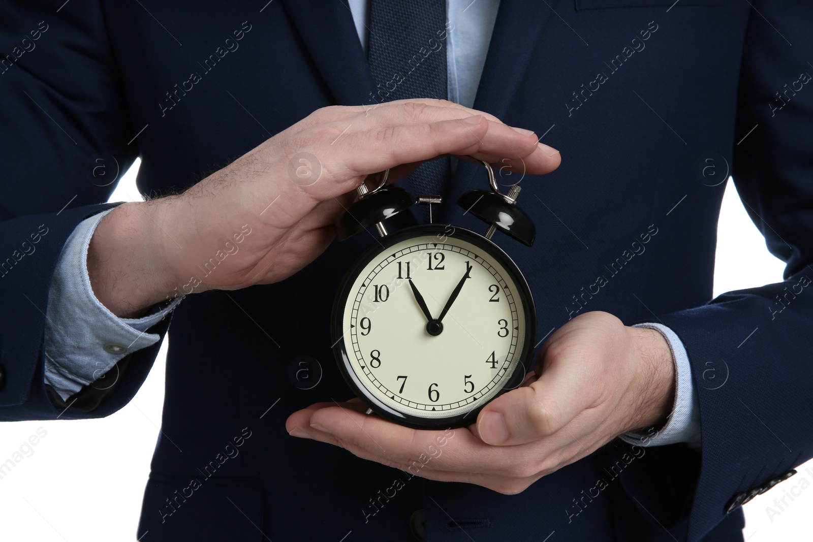 Photo of Businessman holding alarm clock, closeup view. Time management