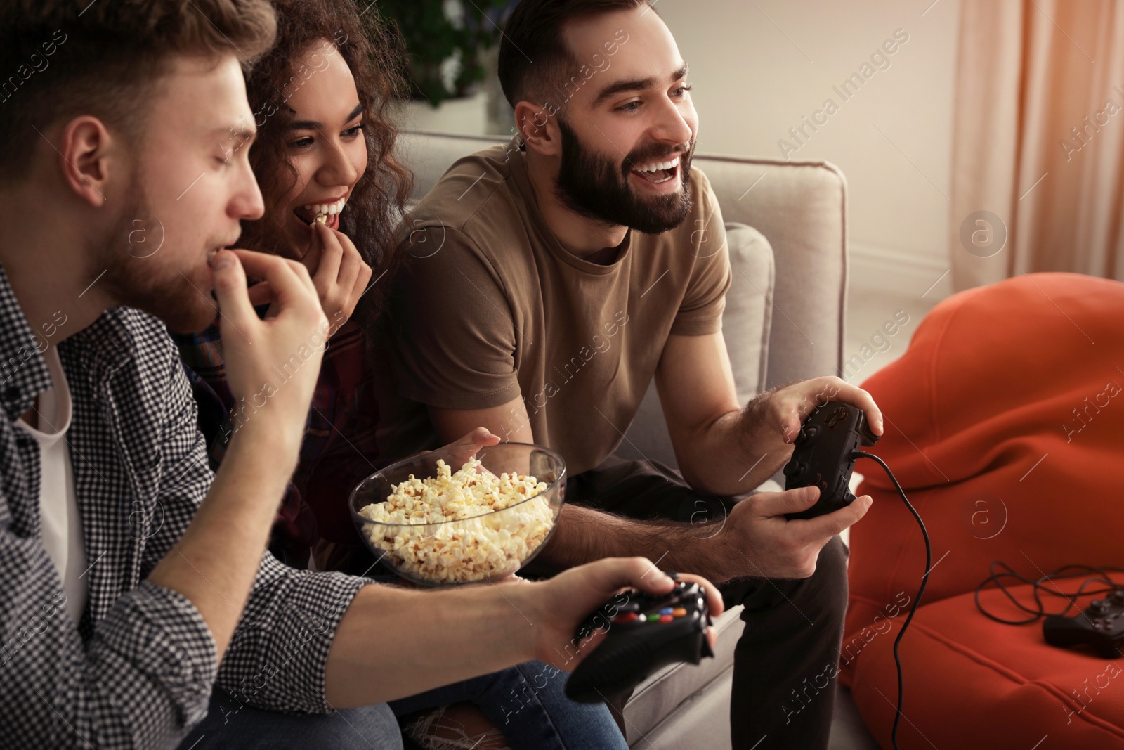 Photo of Emotional friends playing video games at home