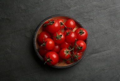 Fresh ripe cherry tomatoes on black table, top view