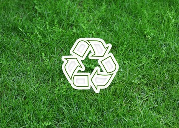 Image of Green grass and illustration of recycling symbol