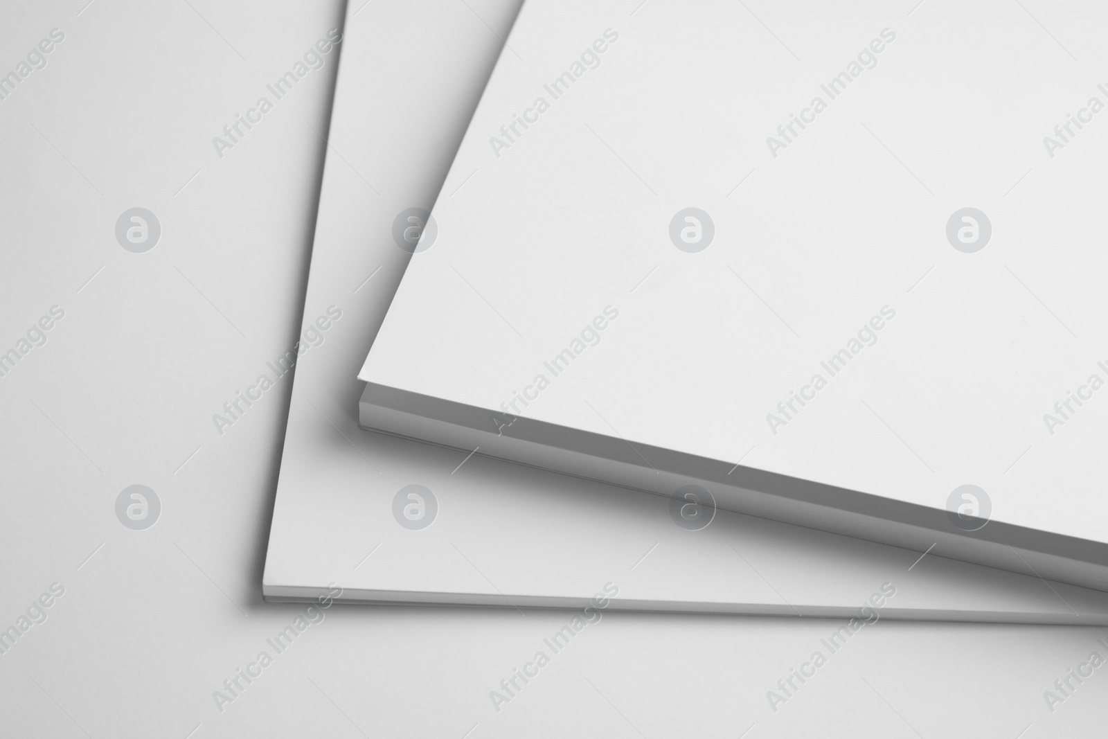 Photo of Blank books on white background, closeup. Mock up for design