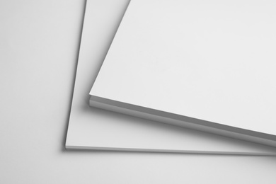 Photo of Blank books on white background, closeup. Mock up for design