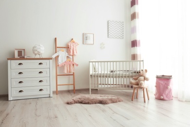 Cozy baby room interior with crib