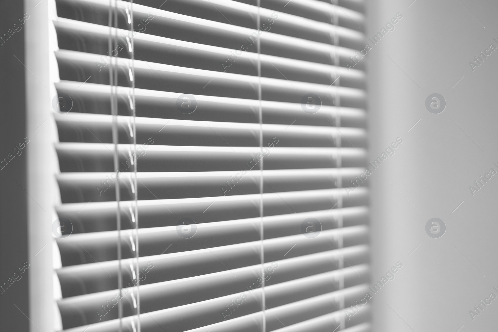 Photo of Closeup view of stylish horizontal window blinds