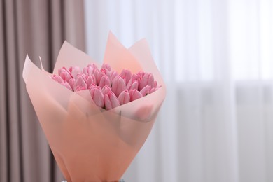 Photo of Bouquet of beautiful pink tulips indoors, space for text