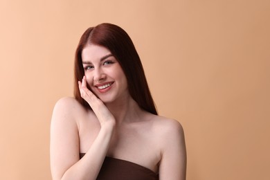 Photo of Portrait of smiling woman on beige background. Space for text