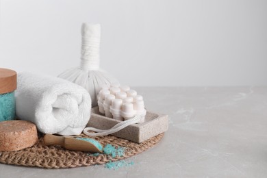 Spa composition with care products on light grey marble table. Space for text