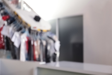 Photo of Blurred view of dry-cleaner's interior with garment conveyor