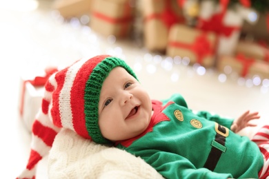 Photo of Cute baby in Christmas costume at home
