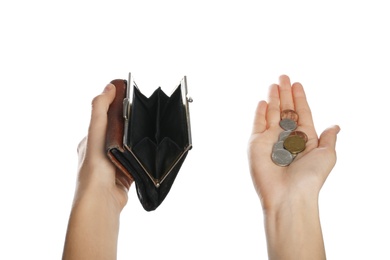 Poor woman holding empty wallet and coins on white background, closeup