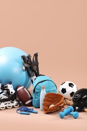 Photo of Many different sports equipment on beige background