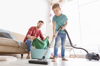 Little boy and his dad cleaning their house together