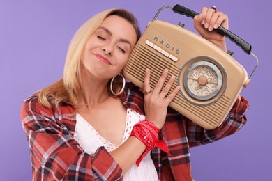 Photo of Hippie woman with retro radio receiver on purple background