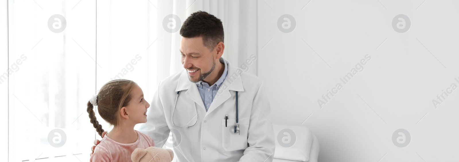 Image of Doctor working with little patient in clinic, space for text. Banner design