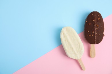 Photo of Glazed ice cream bars on color background, flat lay. Space for text
