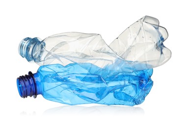 Photo of Crumpled disposable plastic bottles isolated on white